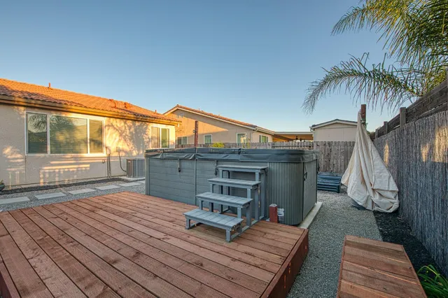 a wooden bench sitting in front of a house