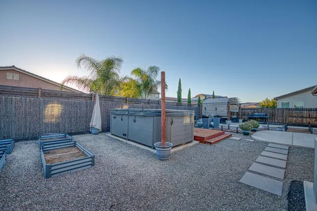 a view of a patio with table and chairs and potted plants