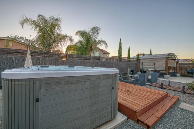 a backyard of a house with table and chairs