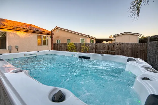 a view of a house with backyard and sitting area