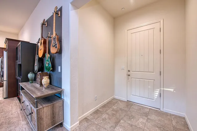 a living room with furniture kitchen view and a large window