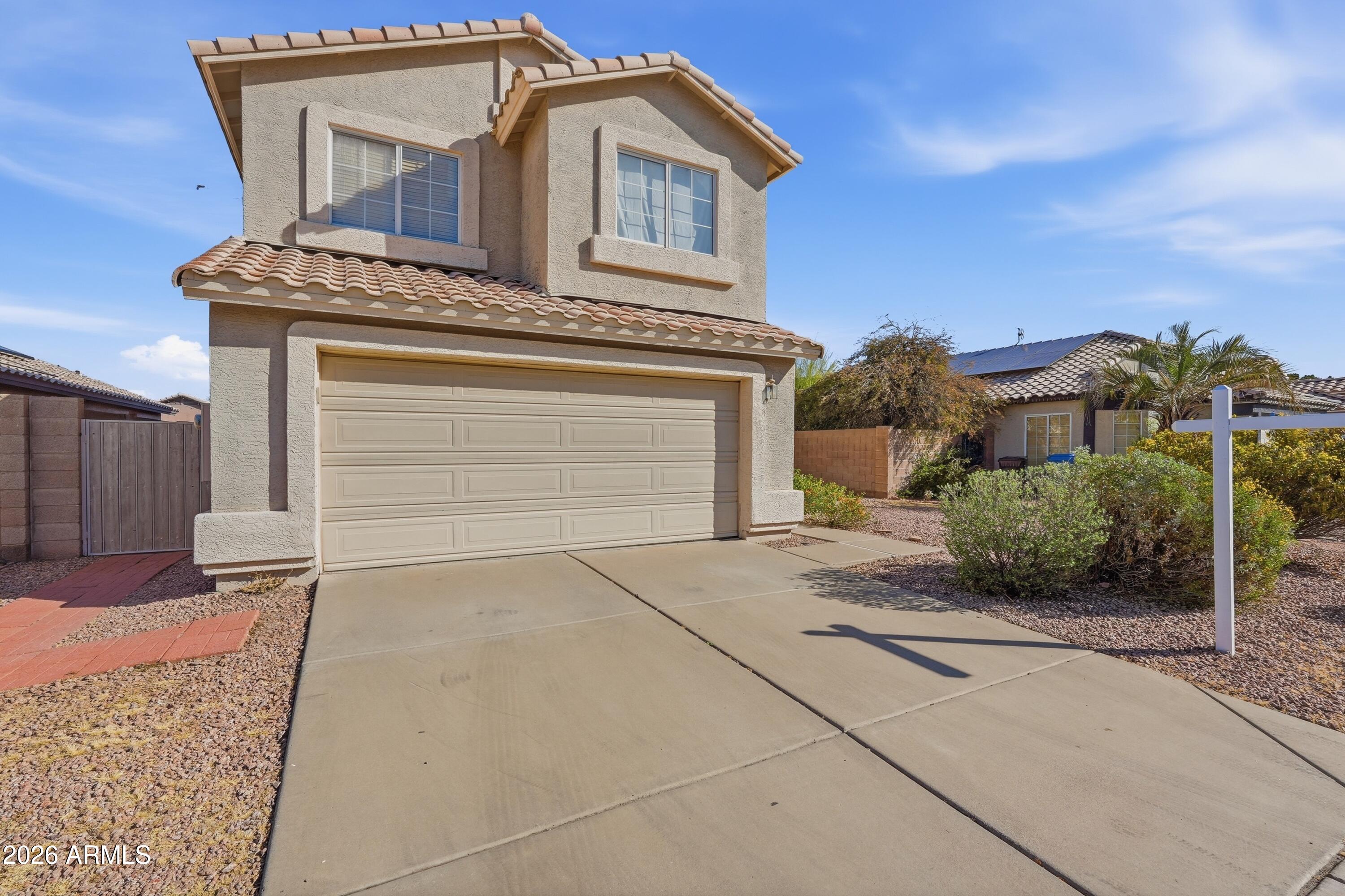 2840 East Wagoner Road Phoenix, AZ 85032 - Photo 1 of 34 a front view of a house with a yard and garage