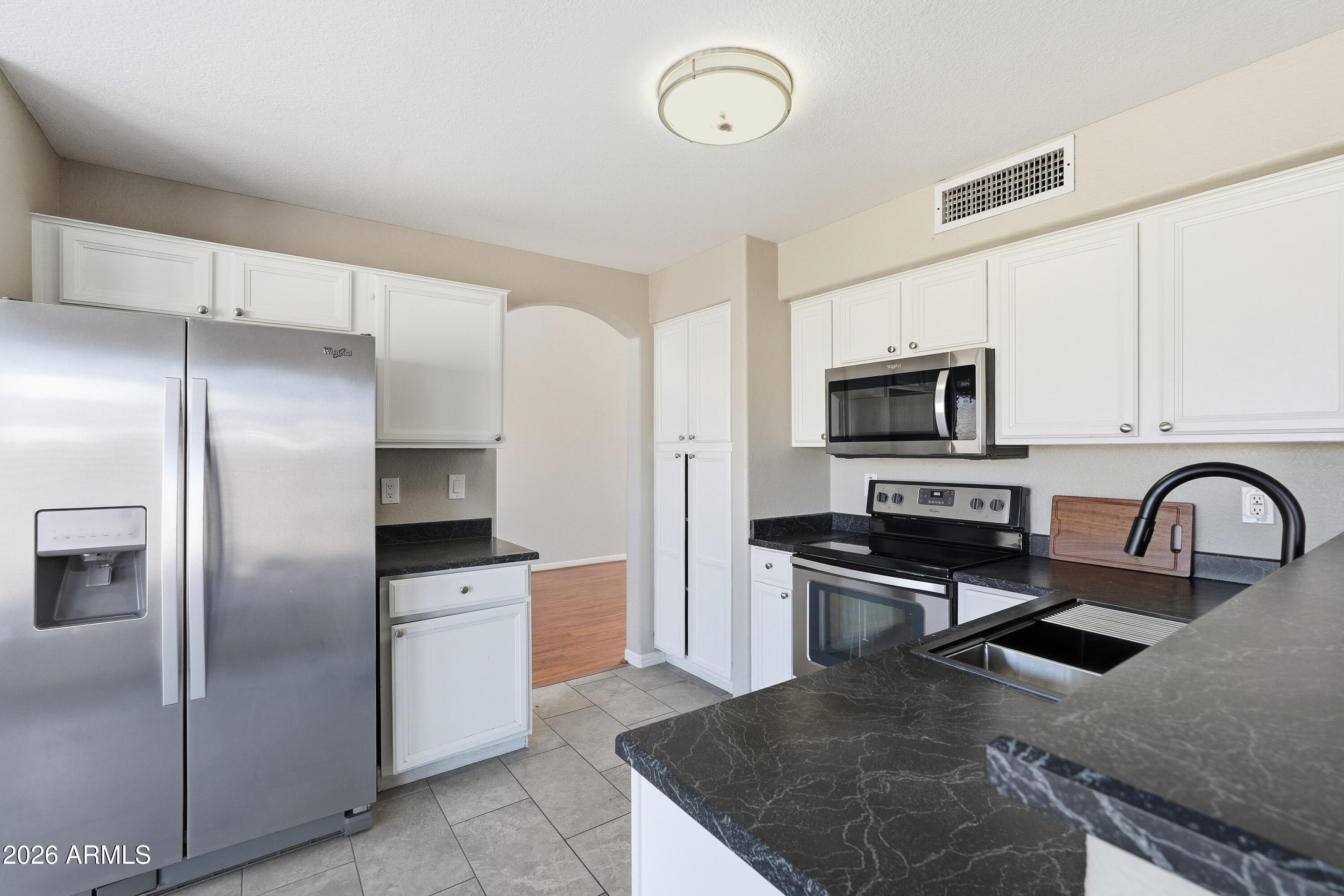 2840 East Wagoner Road Phoenix, AZ 85032 - Photo 13 of 34 a kitchen with stainless steel appliances granite countertop a refrigerator a stove a sink and a microwave