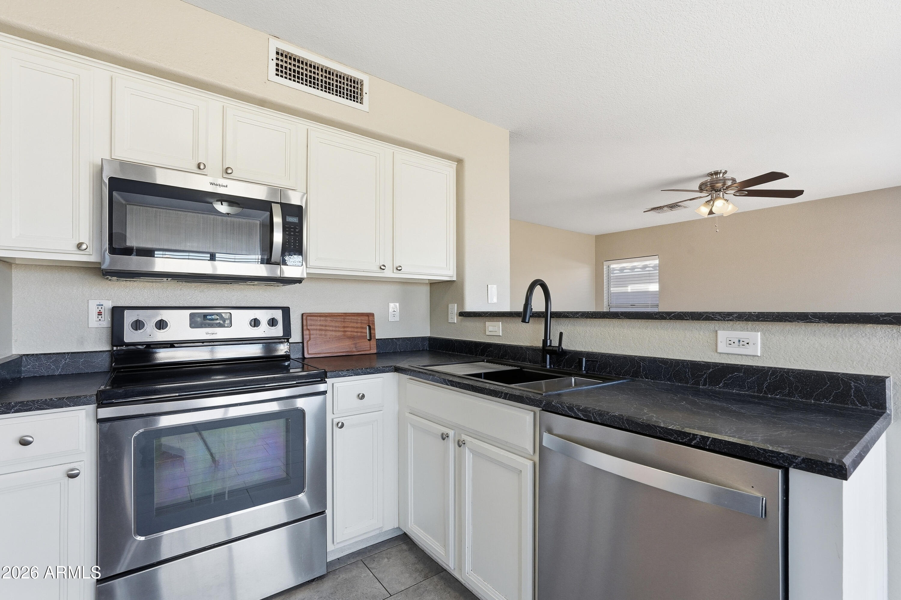 2840 East Wagoner Road Phoenix, AZ 85032 - Photo 16 of 34 a kitchen with granite countertop a stove sink and cabinets