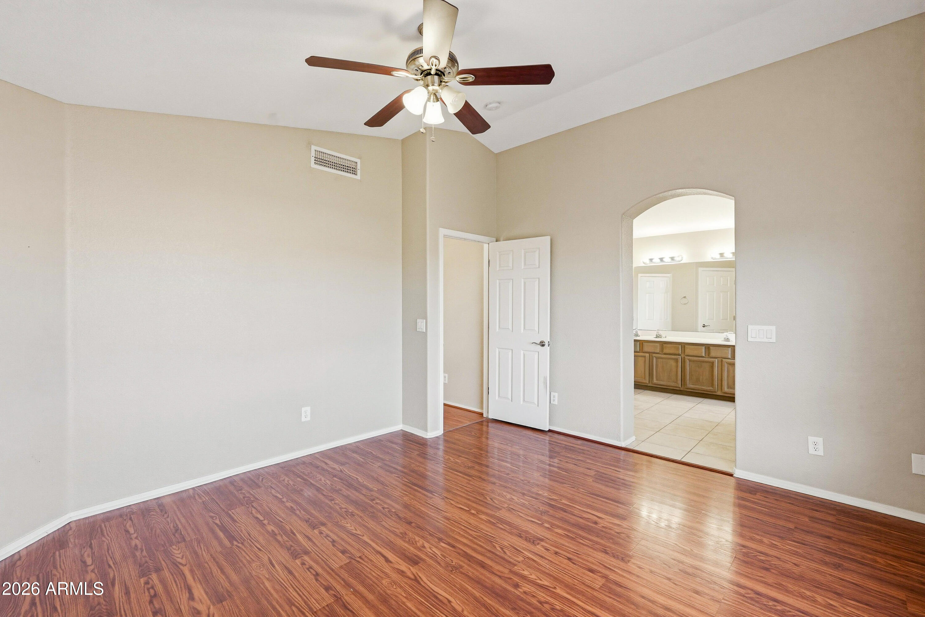 2840 East Wagoner Road Phoenix, AZ 85032 - Photo 18 of 34 an empty room with wooden floor chandelier fan and windows