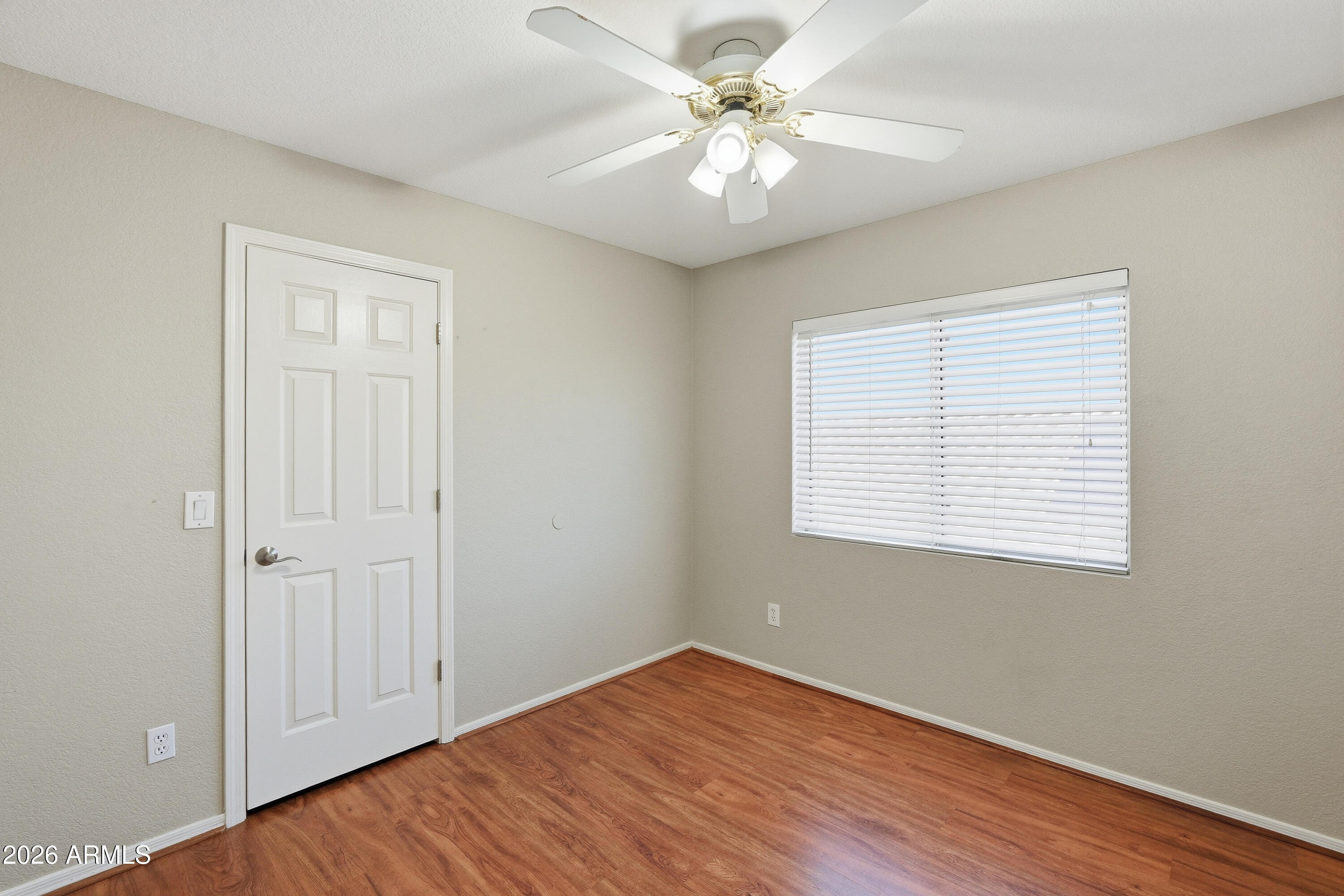 2840 East Wagoner Road Phoenix, AZ 85032 - Photo 19 of 34 a view of an empty room with wooden floor and a window