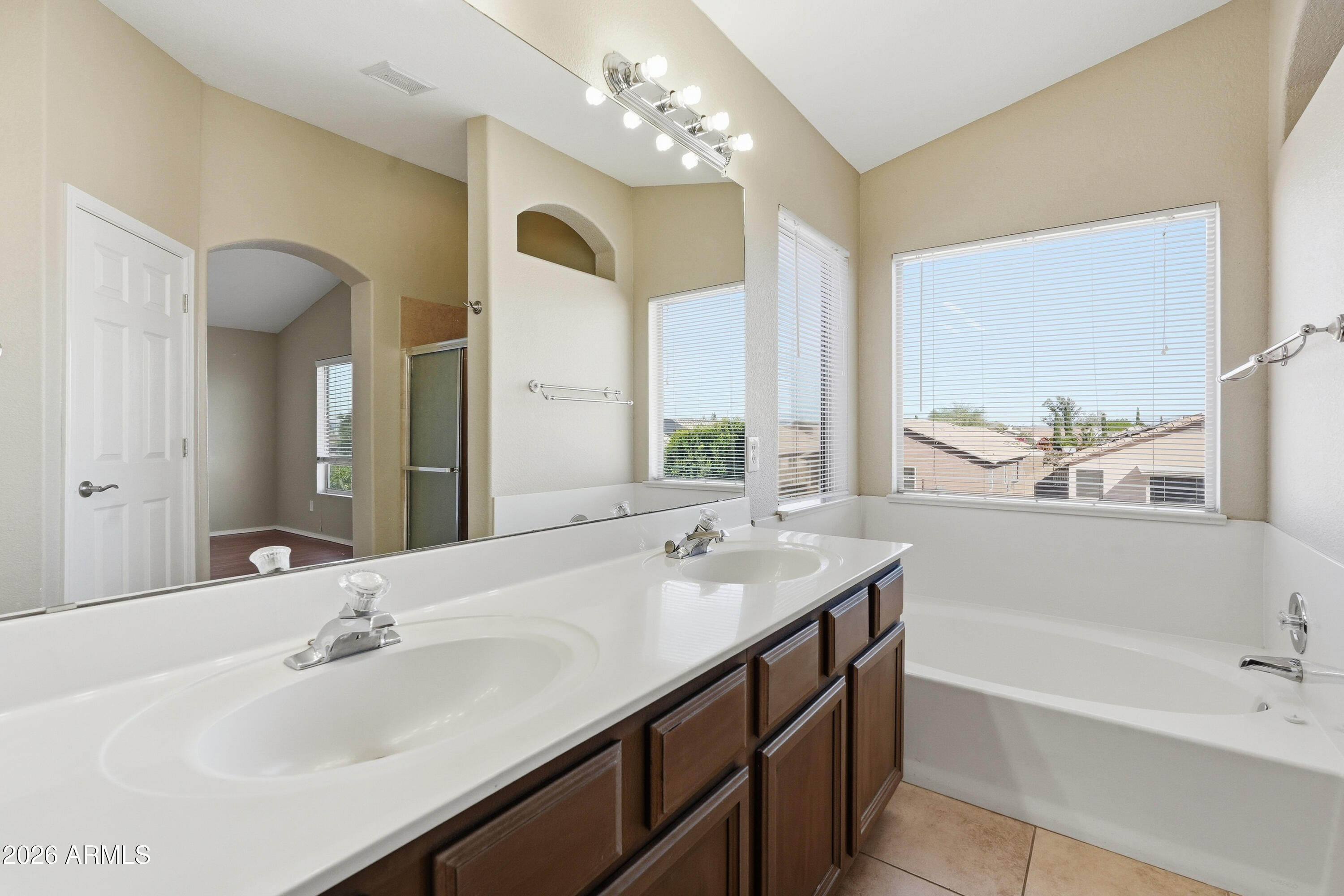 2840 East Wagoner Road Phoenix, AZ 85032 - Photo 26 of 34 a bathroom with a tub sink and mirror
