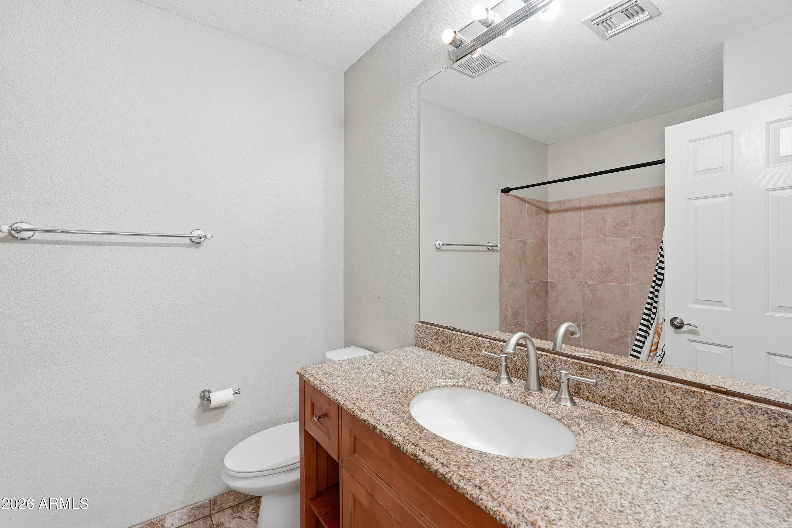 2840 East Wagoner Road Phoenix, AZ 85032 - Photo 28 of 34 a bathroom with a granite countertop sink toilet and a mirror