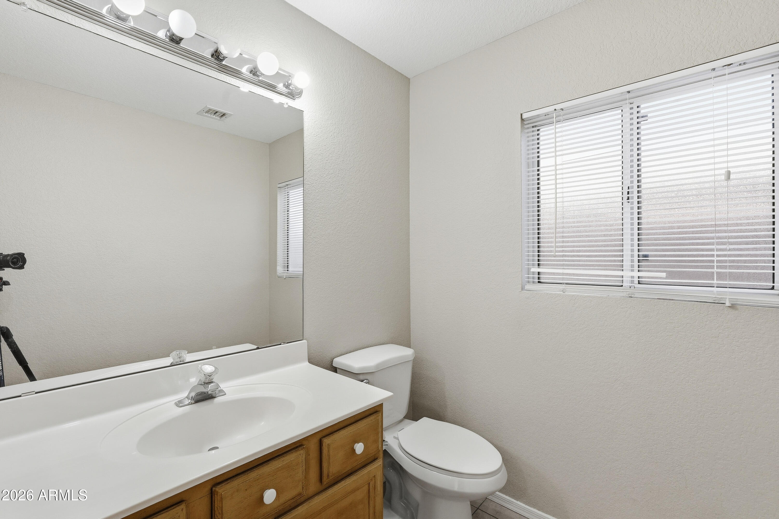 2840 East Wagoner Road Phoenix, AZ 85032 - Photo 29 of 34 a bathroom with a sink a toilet and a mirror
