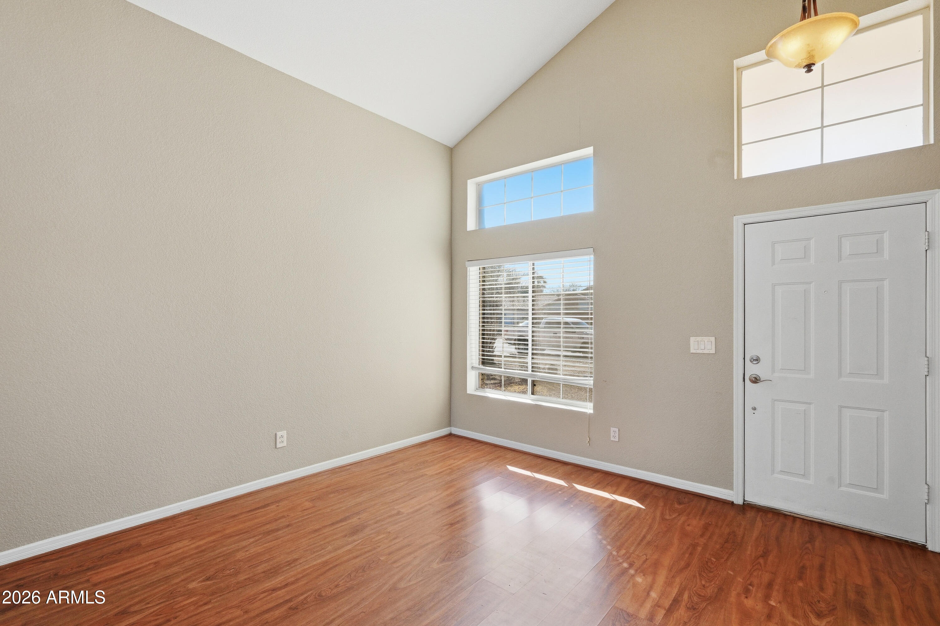 2840 East Wagoner Road Phoenix, AZ 85032 - Photo 4 of 34 an empty room with wooden floor and windows