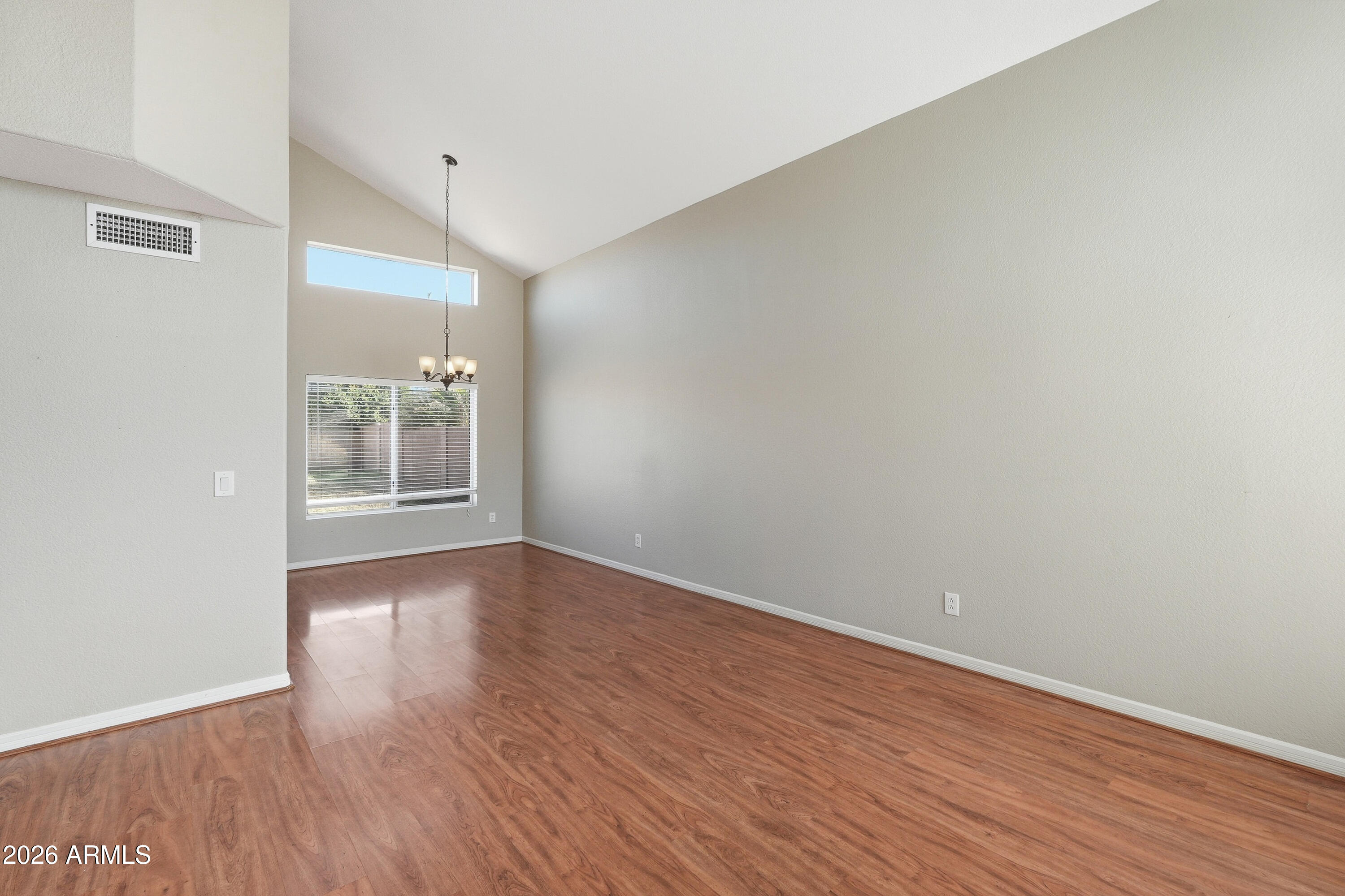 2840 East Wagoner Road Phoenix, AZ 85032 - Photo 6 of 34 a view of wooden floor and windows in a room