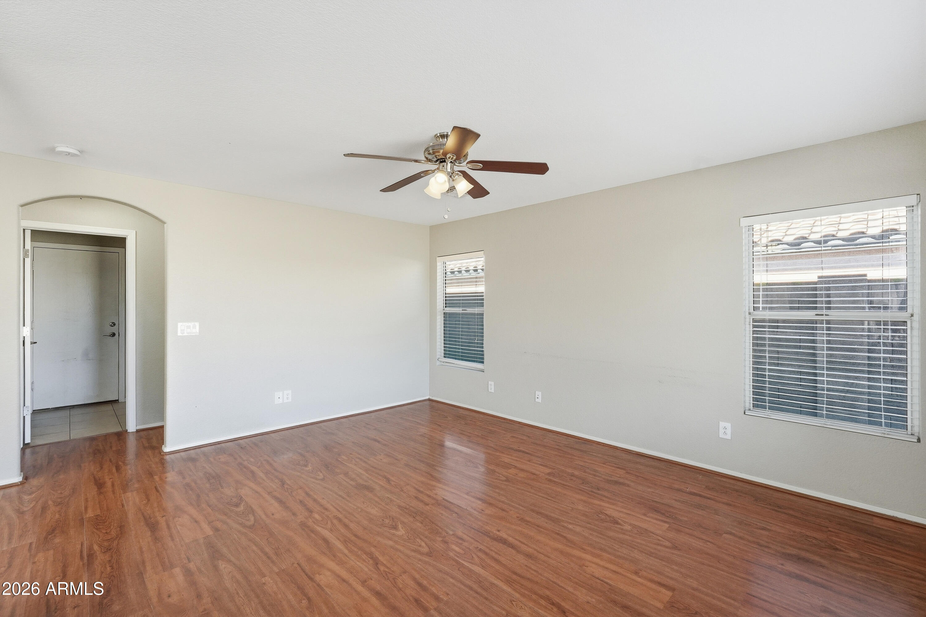 2840 East Wagoner Road Phoenix, AZ 85032 - Photo 8 of 34 a view of a room with wooden floor and a ceiling fan