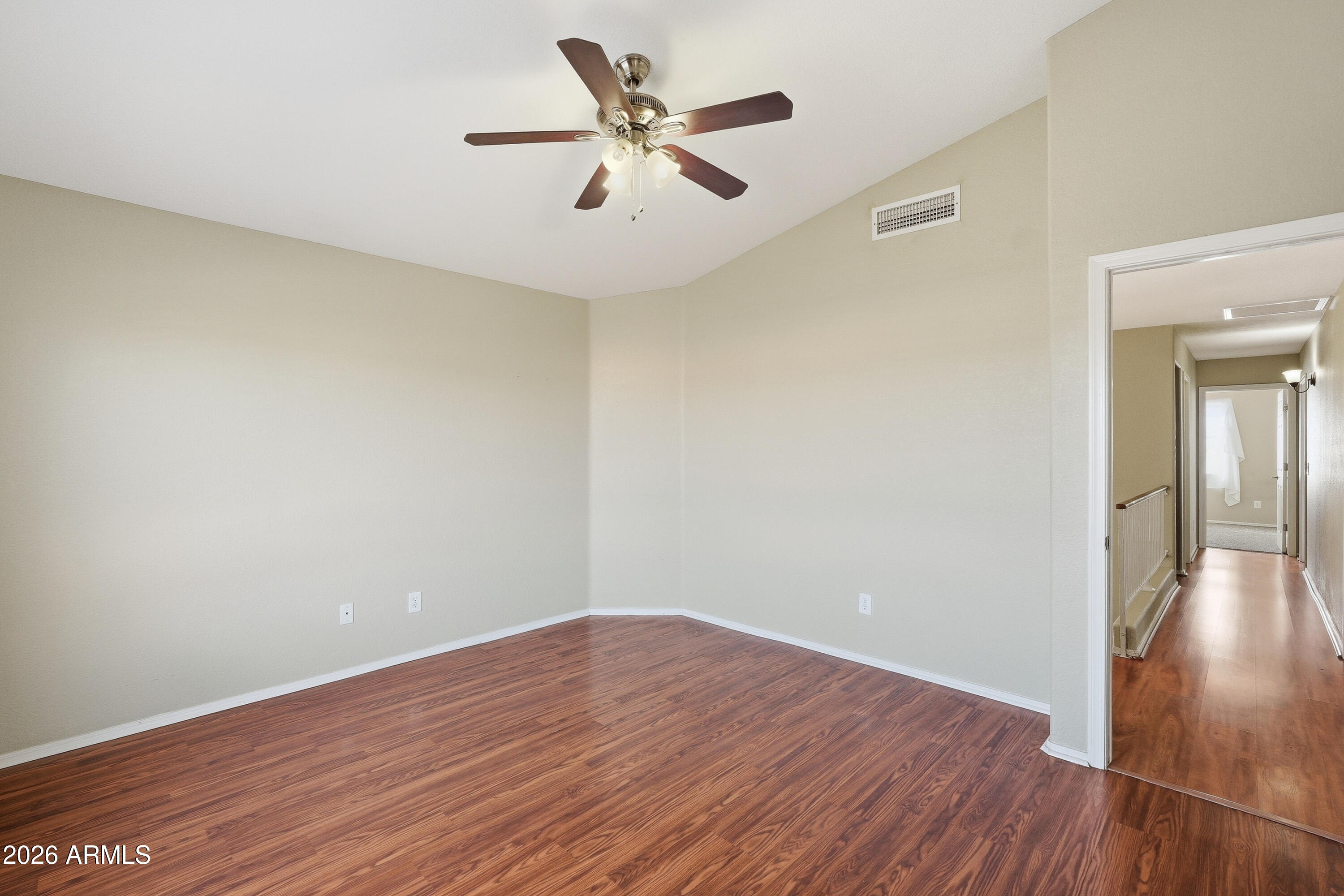 2840 East Wagoner Road Phoenix, AZ 85032 - Photo 10 of 34 an empty room with wooden floor and a ceiling fan