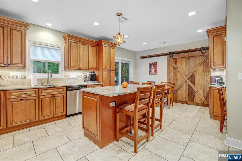165 Pine Street Hackensack, NJ 07601 - Photo 12 of 41 a kitchen with stainless steel appliances granite countertop a sink and a refrigerator