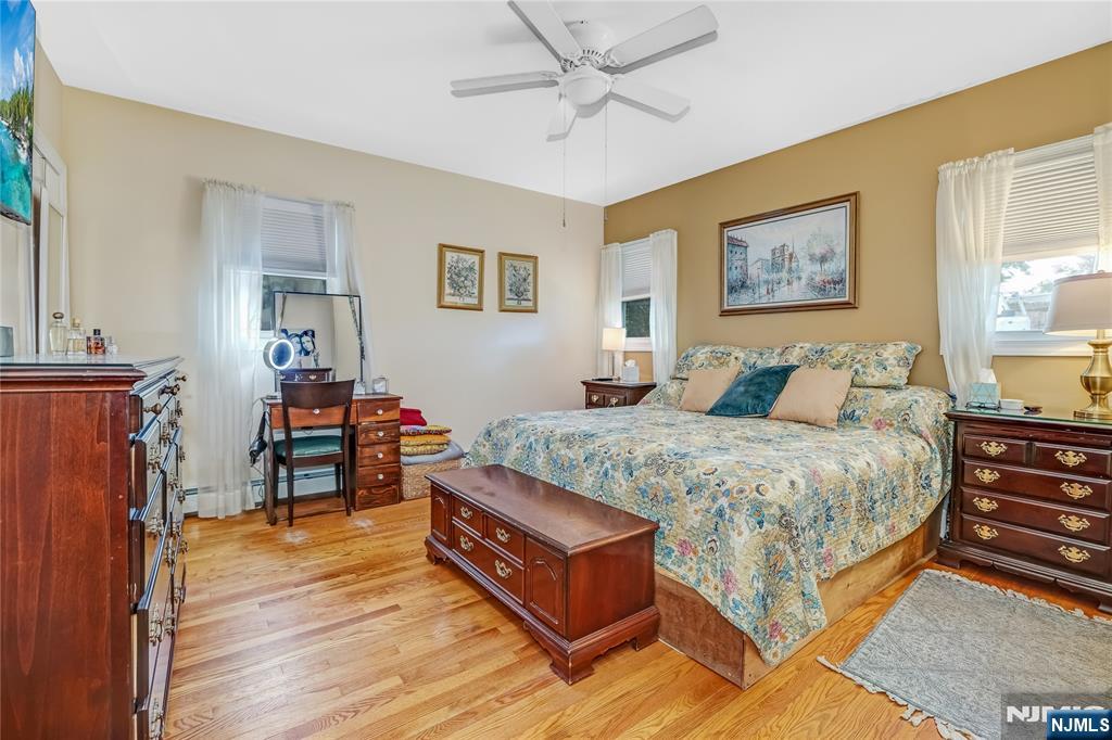 165 Pine Street Hackensack, NJ 07601 - Photo 16 of 41 a bedroom with a bed and a table in it