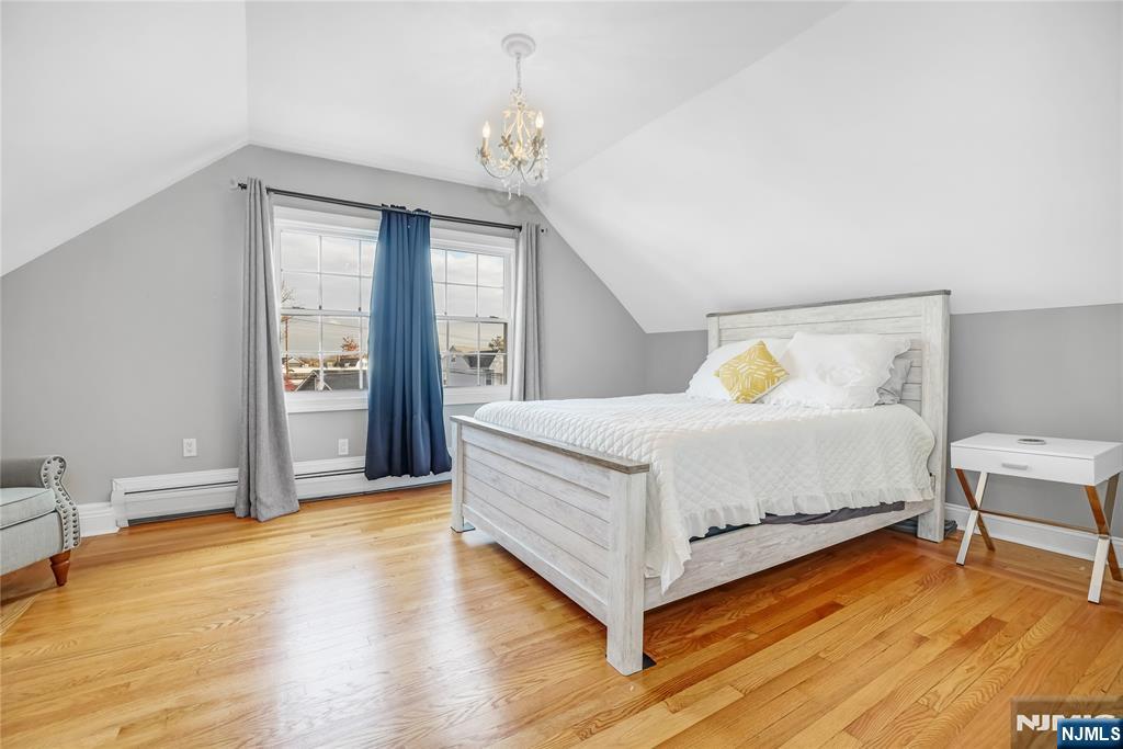 165 Pine Street Hackensack, NJ 07601 - Photo 21 of 41 a bedroom with a bed and a table in it