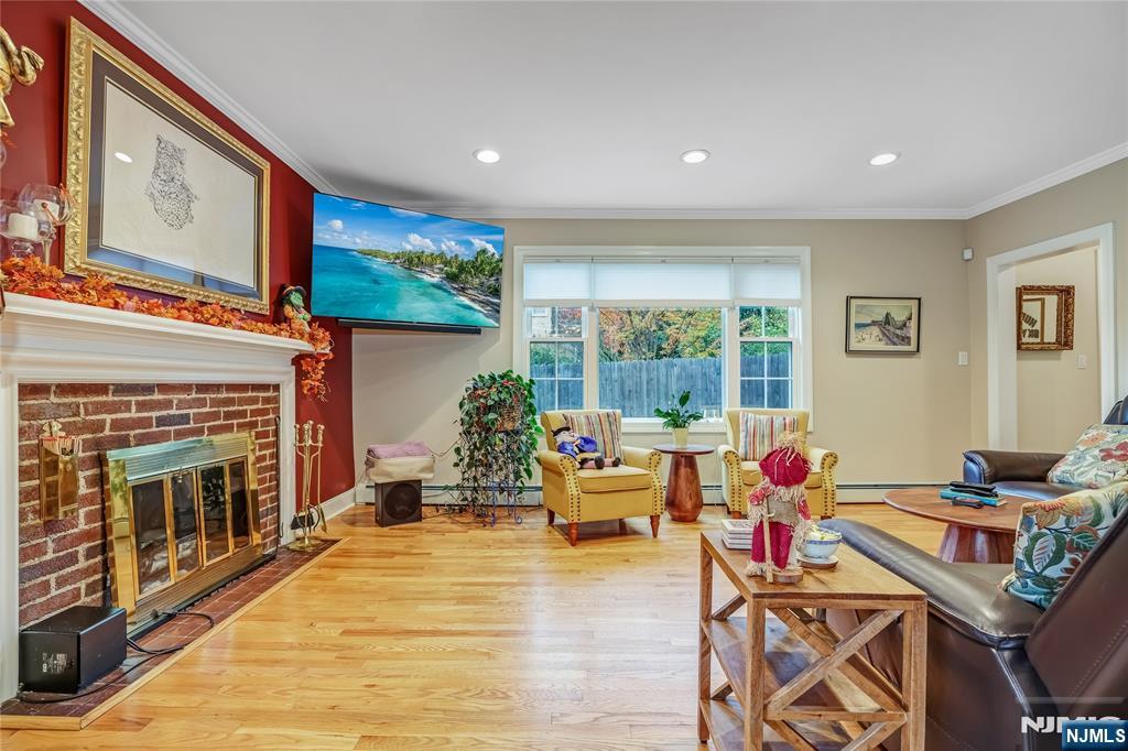 165 Pine Street Hackensack, NJ 07601 - Photo 5 of 41 a living room with furniture a fireplace and a flat screen tv