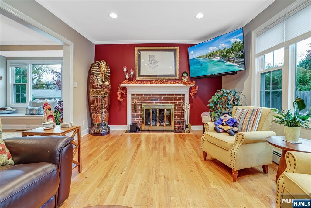 165 Pine Street Hackensack, NJ 07601 - Photo 6 of 41 a living room with furniture a fireplace and a large window