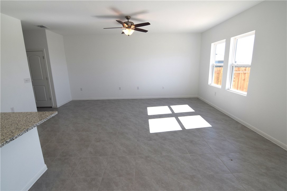 6705 Routenburn Street Austin, TX 78754 - Photo 7 of 18 an empty room with windows and fan