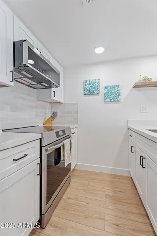 a kitchen with a refrigerator and a sink