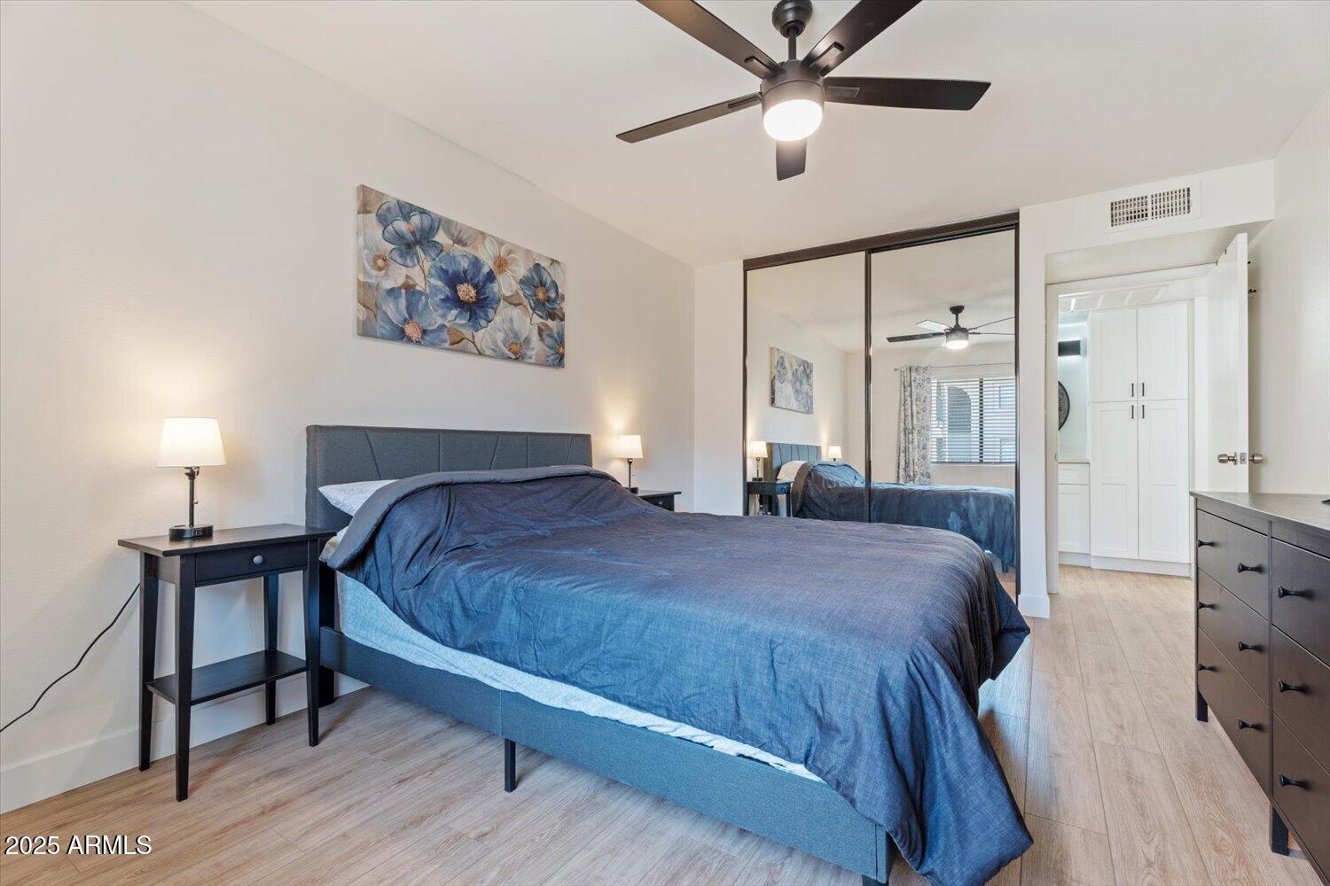 3033 East Devonshire Avenue, Unit 2003 Phoenix, AZ 85016 - Photo 12 of 32 a bedroom with a bed and a chandelier