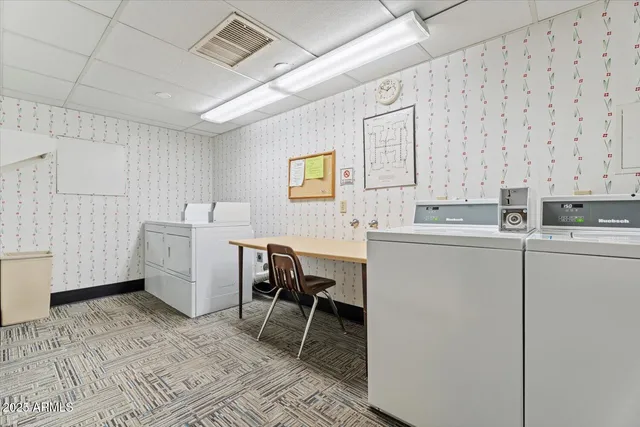 a room with furniture a rug and white walls