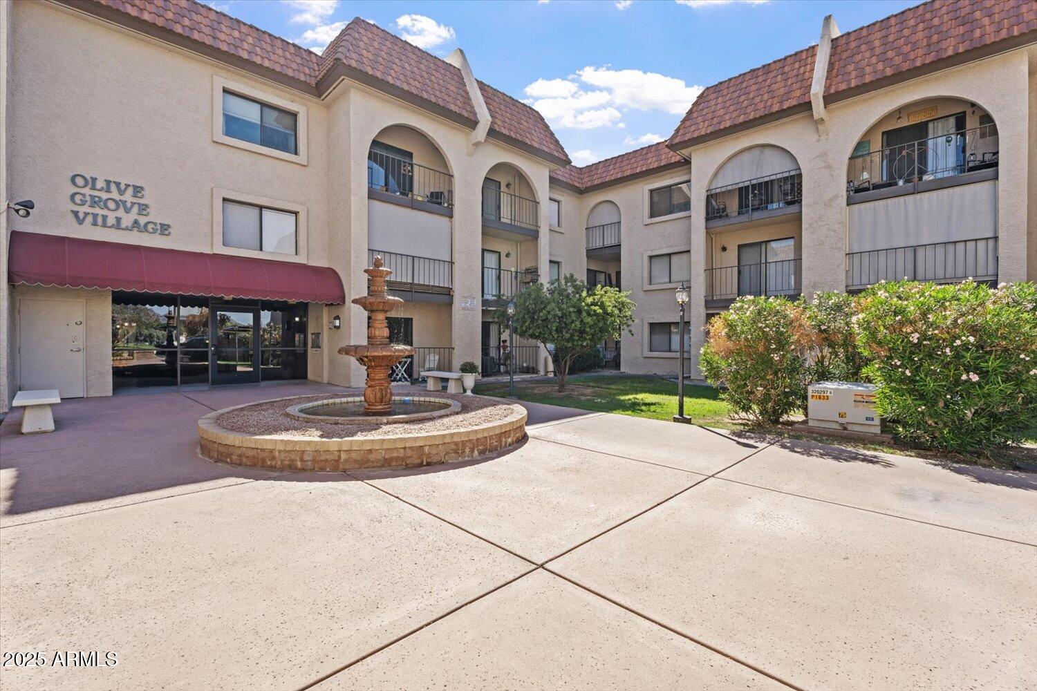 3033 East Devonshire Avenue, Unit 2003 Phoenix, AZ 85016 - Photo 3 of 32 a front view of a house with yard and green space