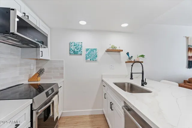 a view of a livingroom with furniture wooden floor and a rug