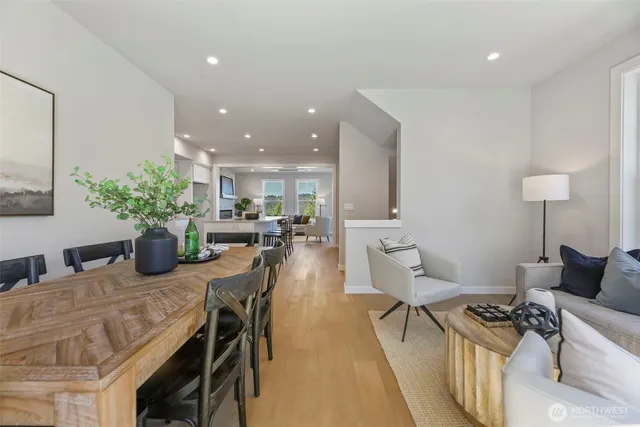 a dining room with furniture and wooden floor