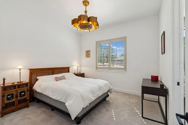 a front view of a house with a yard and trees around