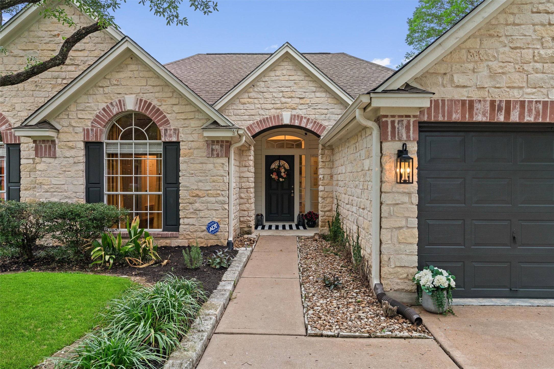 9305 Lightwood Loop Austin, TX 78748 - Photo 1 of 40 a front view of a house with garden