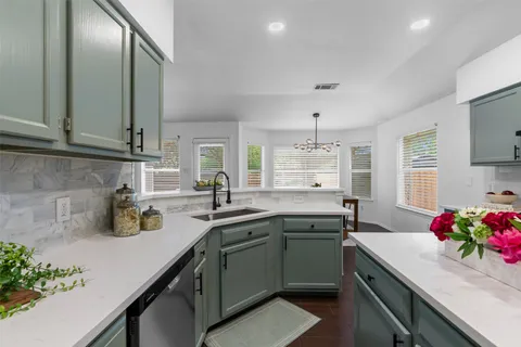 a kitchen with a sink stove and cabinets