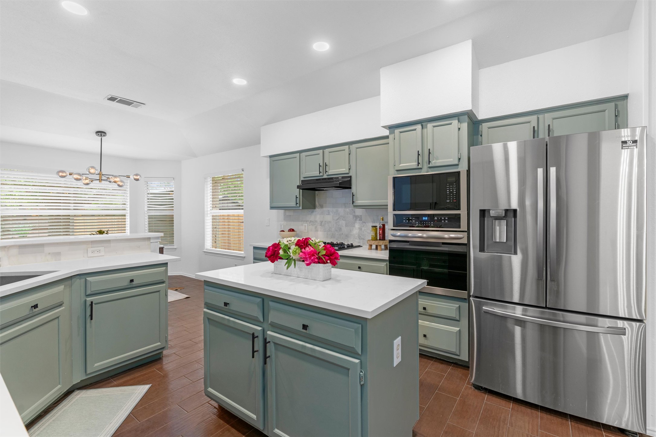 9305 Lightwood Loop Austin, TX 78748 - Photo 14 of 40 a kitchen with a sink stainless steel appliances a refrigerator and a sink