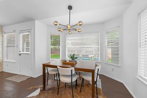 a dining room with furniture and window