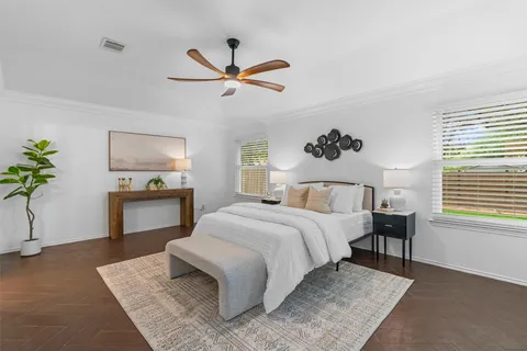 a bedroom with a bed and a chandelier
