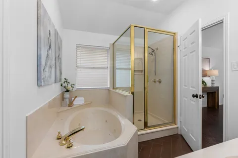a bathroom with a tub and shower