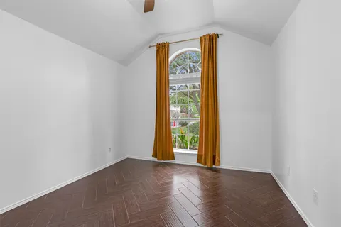 an empty room with windows and entrance