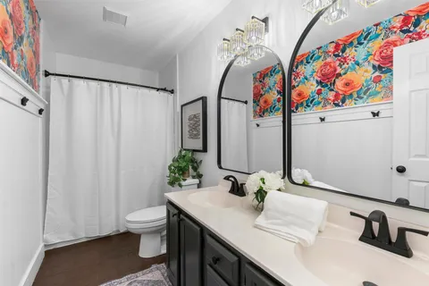 a bathroom with a sink vanity and a mirror