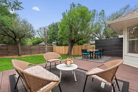 a view of a house with backyard and sitting area