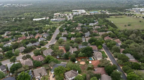 an aerial view of a house with yard