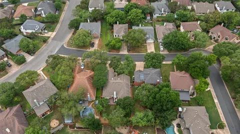 a front view of a house with yard and green space