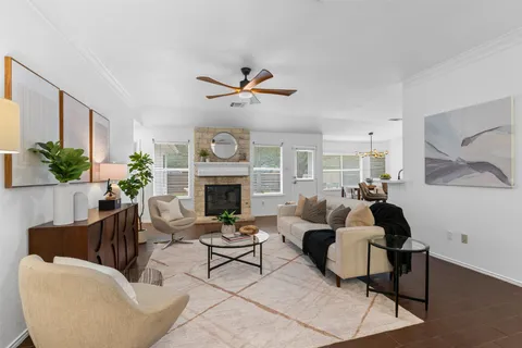 a living room with furniture a fireplace and a large mirror