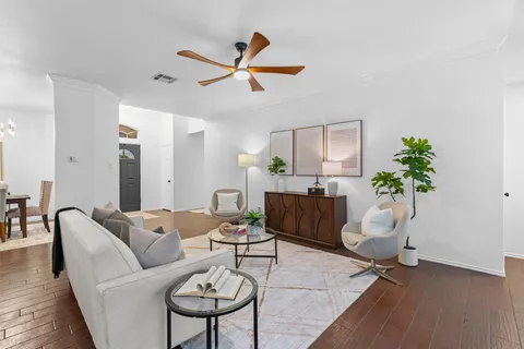 a living room with furniture and a potted plant