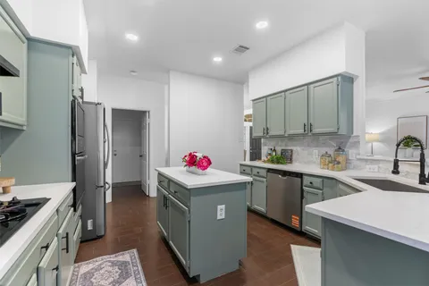 a kitchen with a sink stove and refrigerator