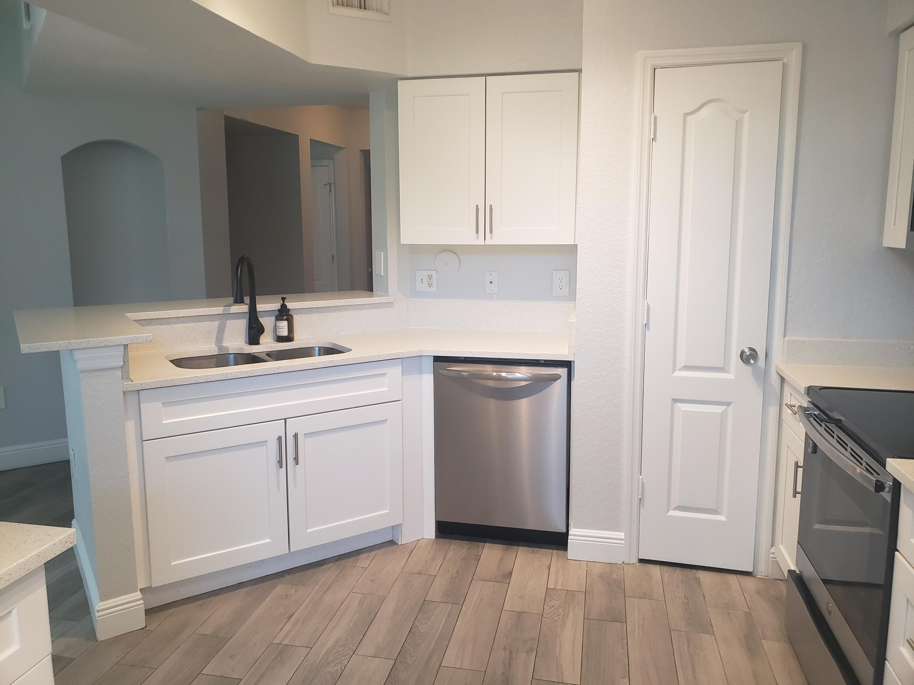 909 Belmont Place, Unit 909 Boynton Beach, FL 33436 - Photo 2 of 26 a bathroom with a sink and a mirror