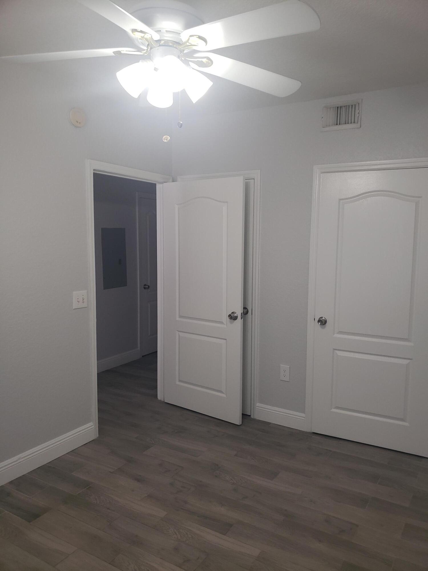 909 Belmont Place, Unit 909 Boynton Beach, FL 33436 - Photo 23 of 26 a view of a room with wooden floor