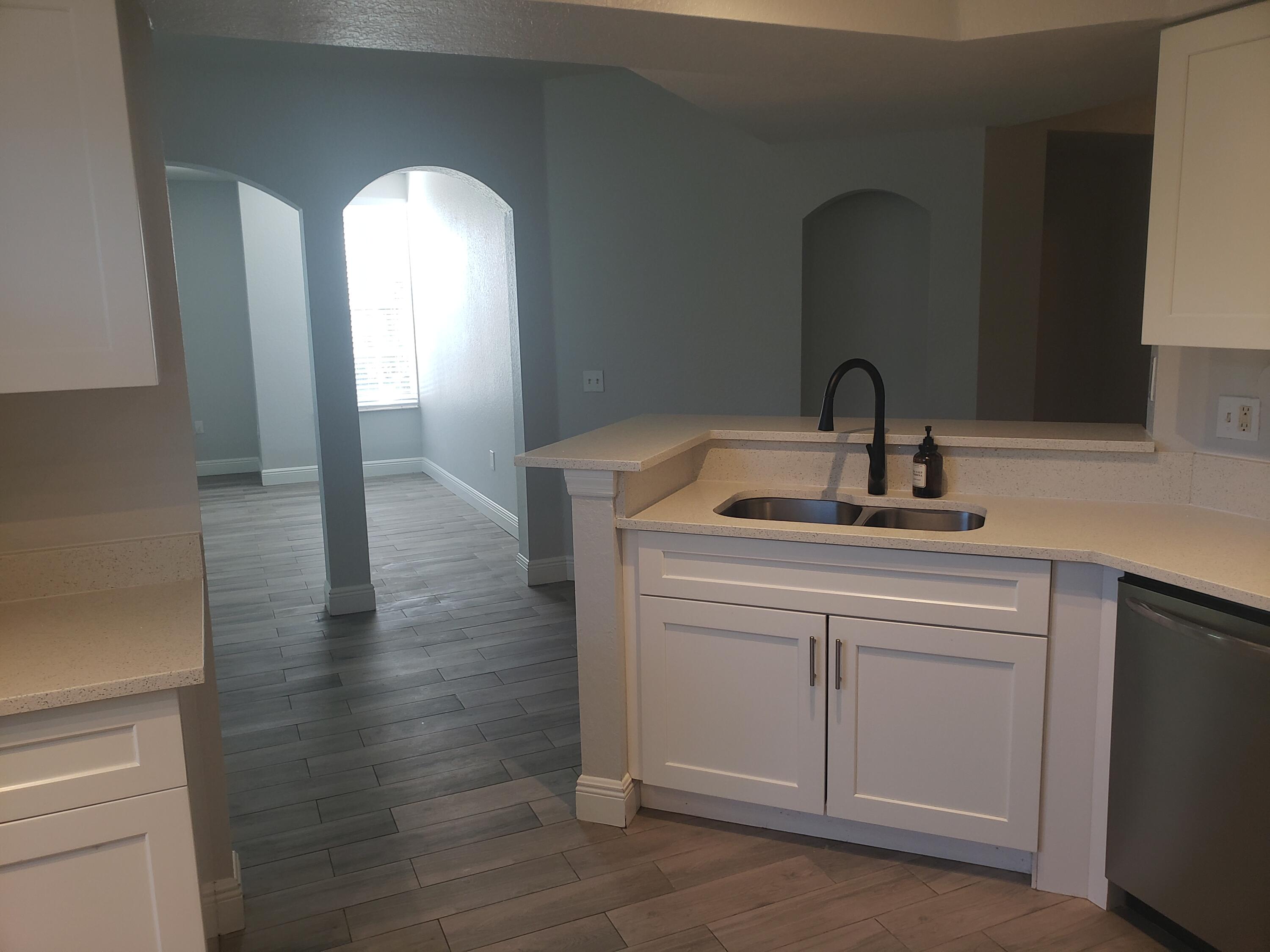 909 Belmont Place, Unit 909 Boynton Beach, FL 33436 - Photo 3 of 26 a kitchen with sink and window