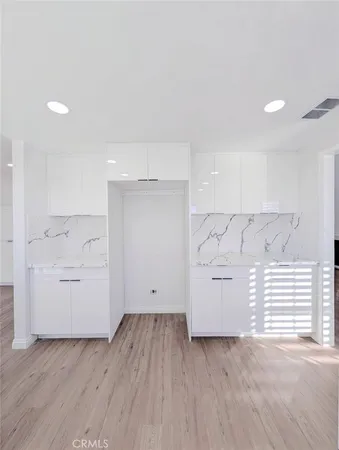 a view of empty room with wooden floor and window