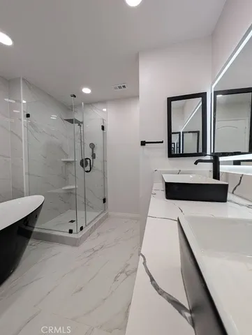 a large white kitchen with a kitchen island a stove a sink and a refrigerator