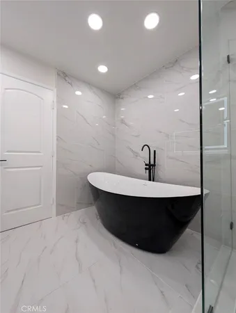a bathroom with a glass shower door